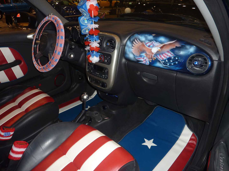 The interior was professionally done by Smitty at Classic Auto Tops here in Indianapolis, In. The seats display Red and White vertical stripes and a top bar of Blue with White embroidered Stars. The door panels are the same.